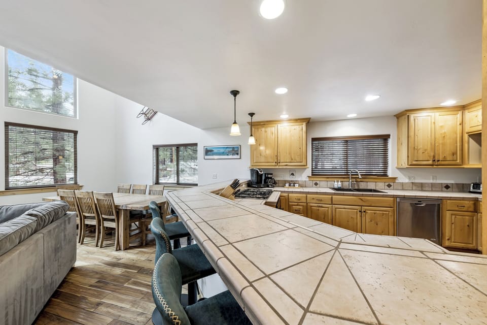 Gather around this stunning open kitchen with spacious island seating where you'll create memorable meals together in your mountain getaway.