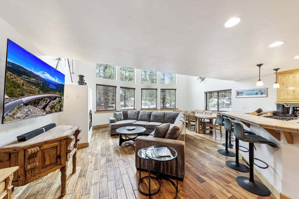 Relax in your bright, open living space with cozy seating, full kitchen, and large windows bringing in natural light.