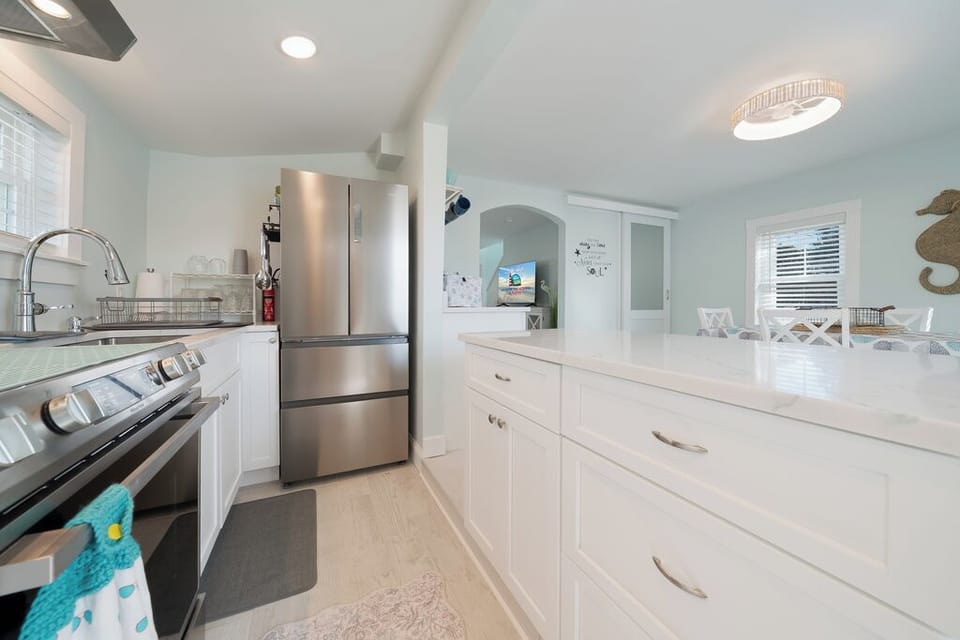 Gorgeous Gourmet Kitchen with Stainless Appliances, gleaming Granite, and beachy white cabinetry.