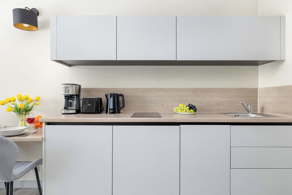 A kitchen countertop featuring appliances such as a coffee maker and toaster. The clean design emphasizes simplicity and utility.