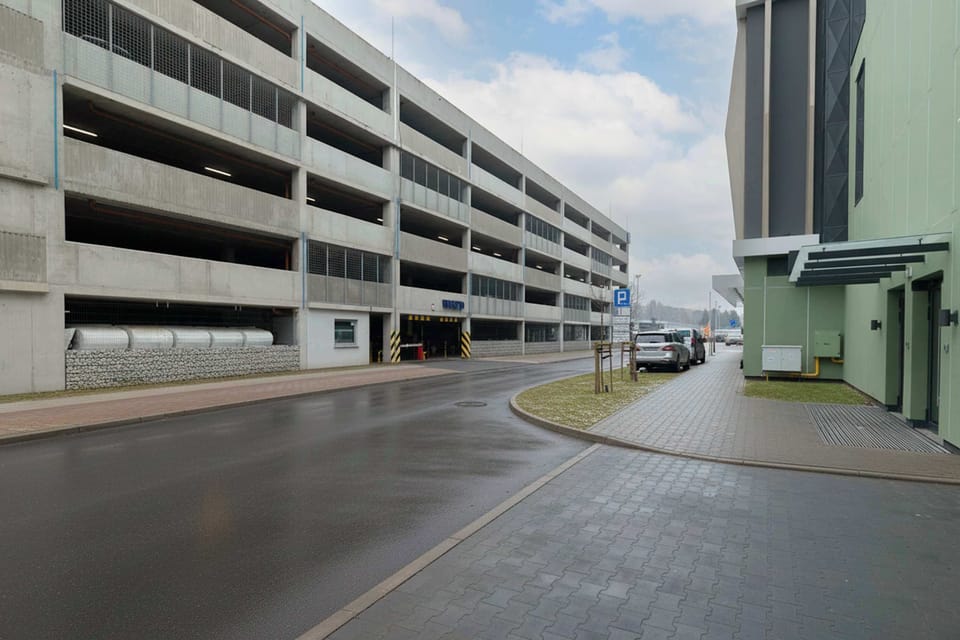 An outdoor view of a multi-story parking structure from the street. The design is practical and easy to navigate.