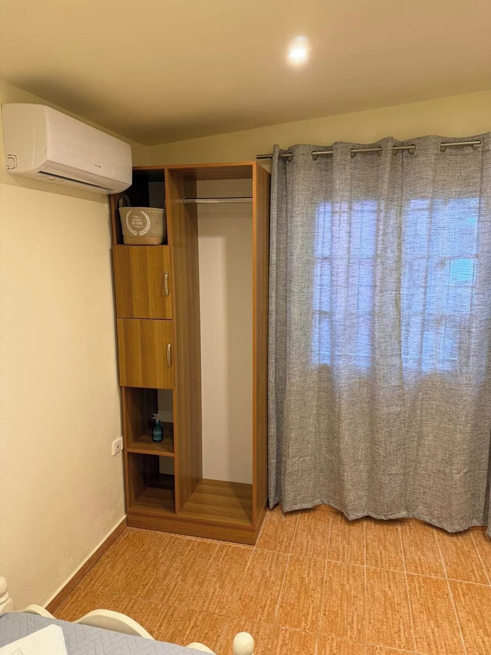 Twin bedroom with wardrobe and window view