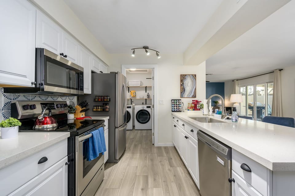 Fully equipped kitchen with stainless steel appliances.