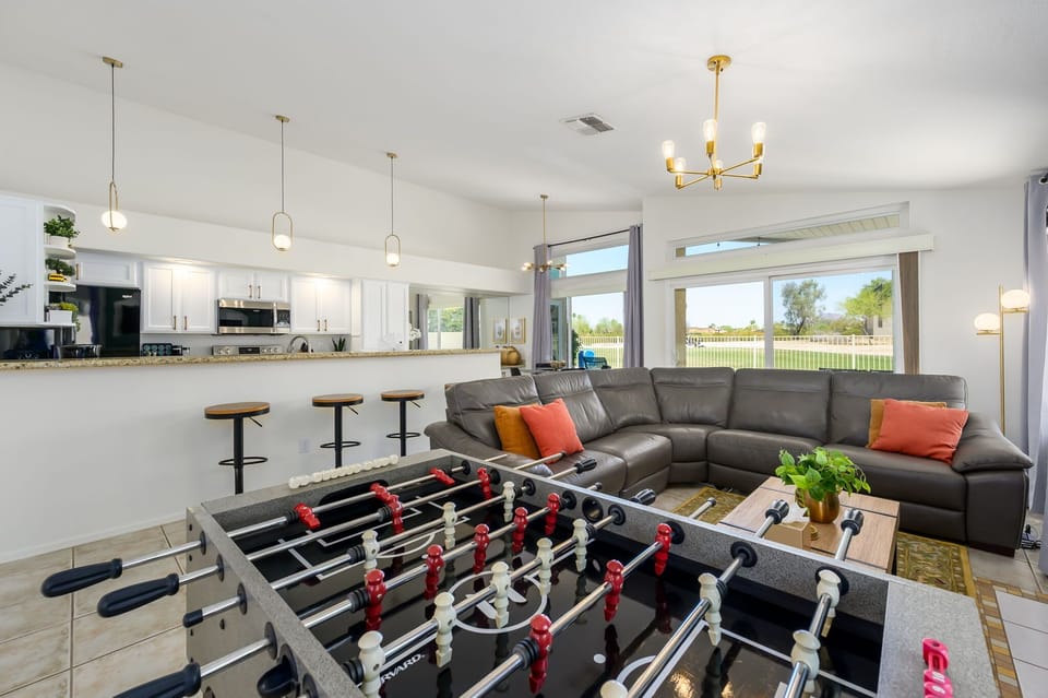 Game area with a foosball table and seating.