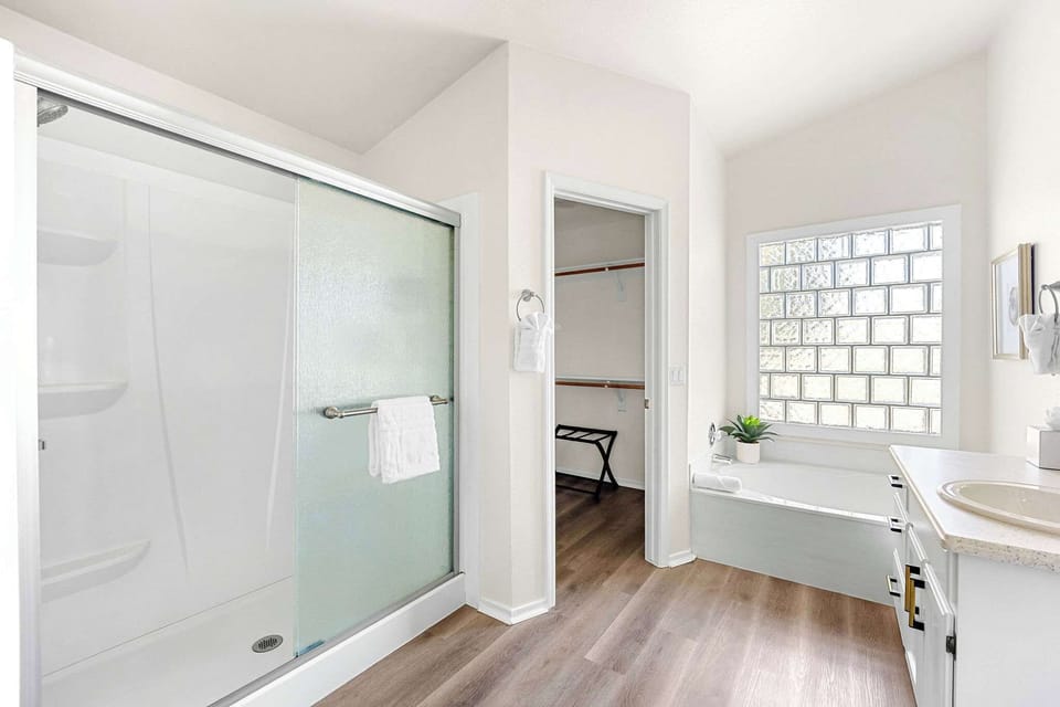 Primary bathroom with a tub and a walk-in shower.