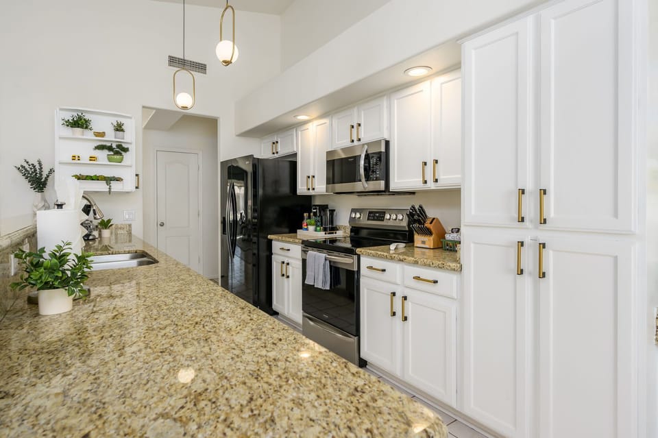Fully equipped kitchen with stainless steel appliances.