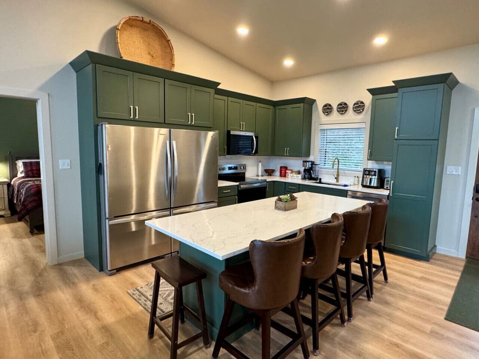 open concept kitchen, double fridge/freezer and island that seats 6, kitchen table for 8