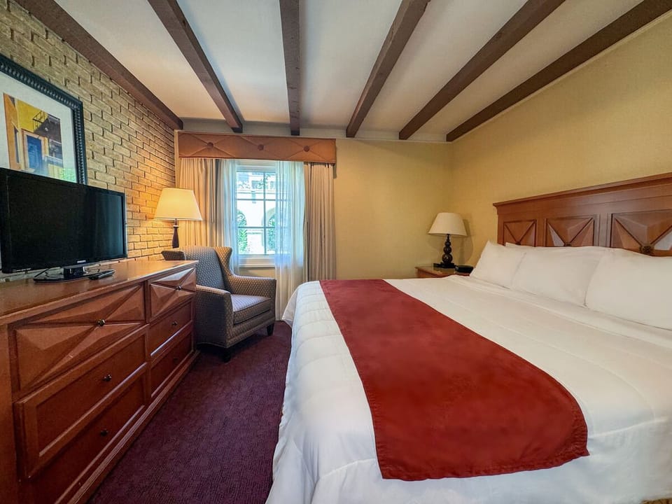 Kick back with in-room TV, cozy chair, and relaxed vibes.