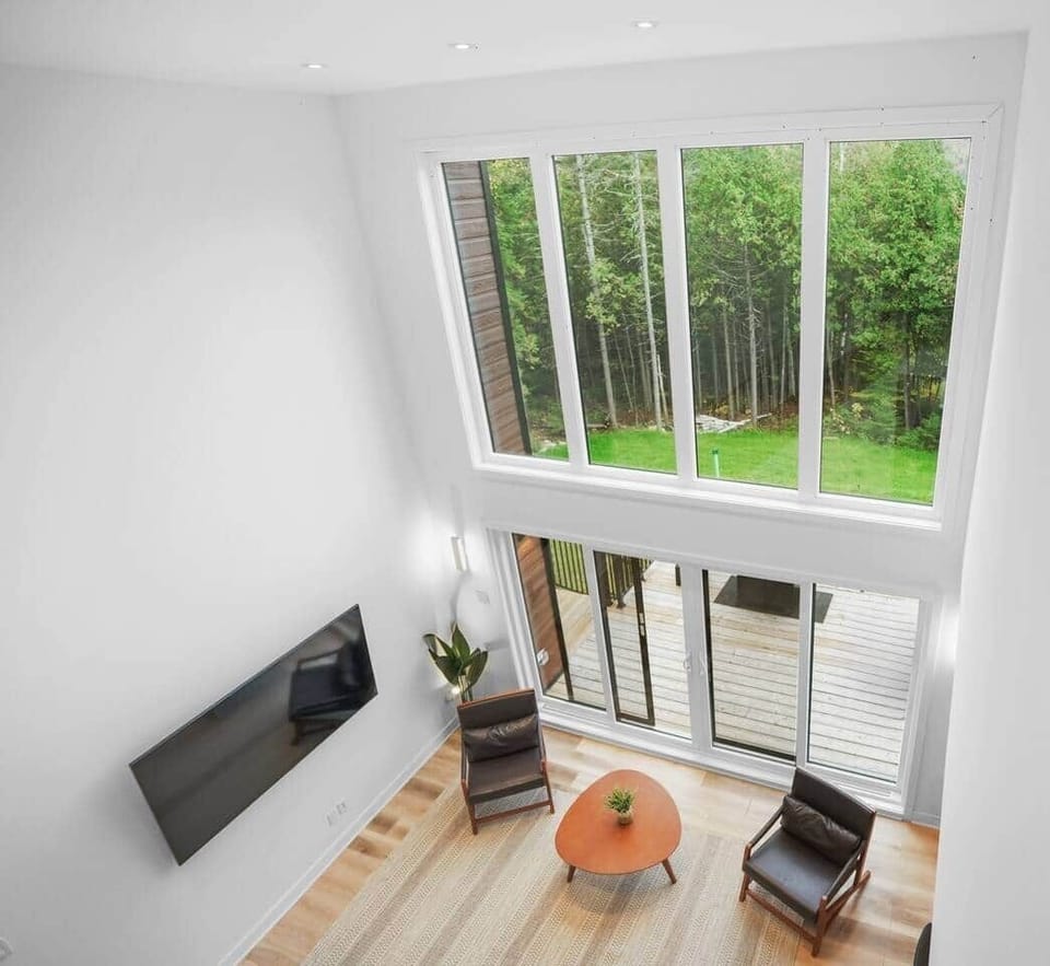 Wake up to the forest views and natural light streaming through the floor-to-ceiling windows 