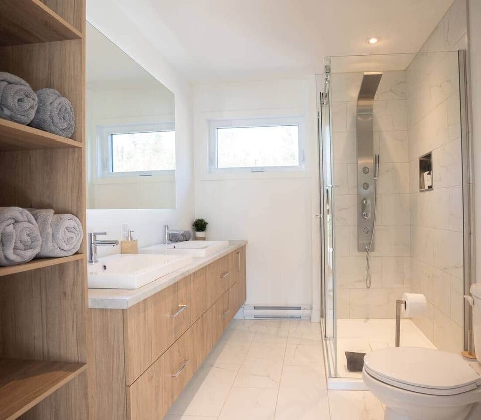 Spacious 2nd-floor bathroom with double sinks & multi-jet walk-in shower
