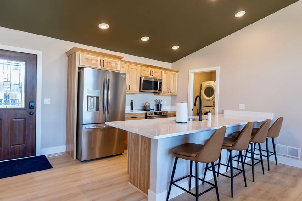 Fully equipped kitchen and island that seats four.