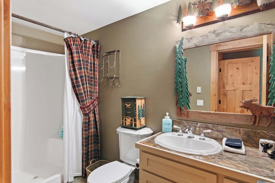 Rustic charm meets cozy comfort in your private bathroom. Woodland-themed décor and warm wood accents create a welcoming mountain retreat vibe where you can unwind after a day exploring.