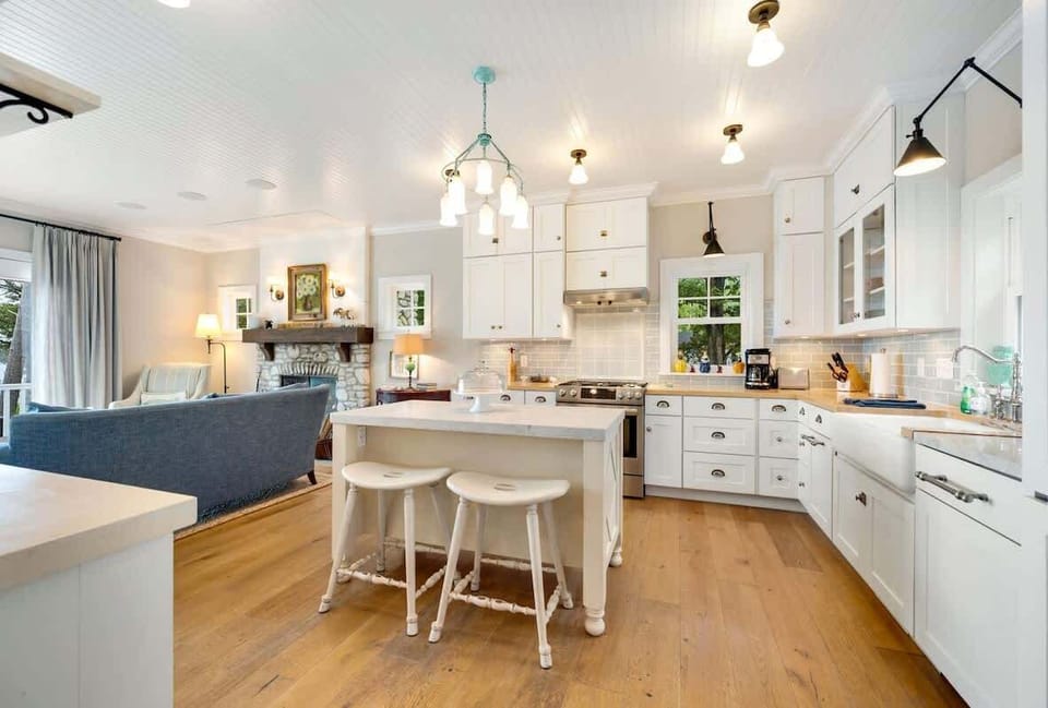The fully equipped kitchen includes classic white cabinetry, butcher block counters, a drip coffee maker, and dishwasher—perfect for preparing meals together.