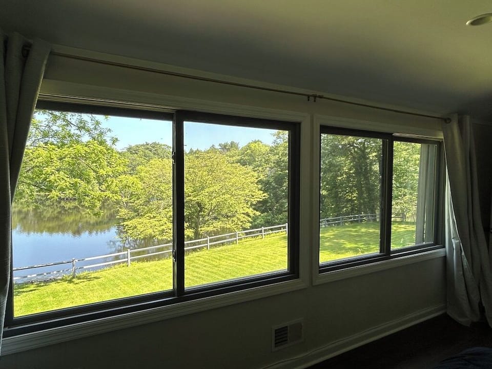 Oversized windows to get a grand view of the lake from the guest bedroom
