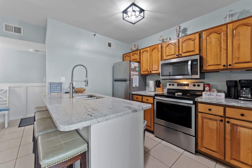 Fully equipped kitchen with stainless appliances and a spacious island