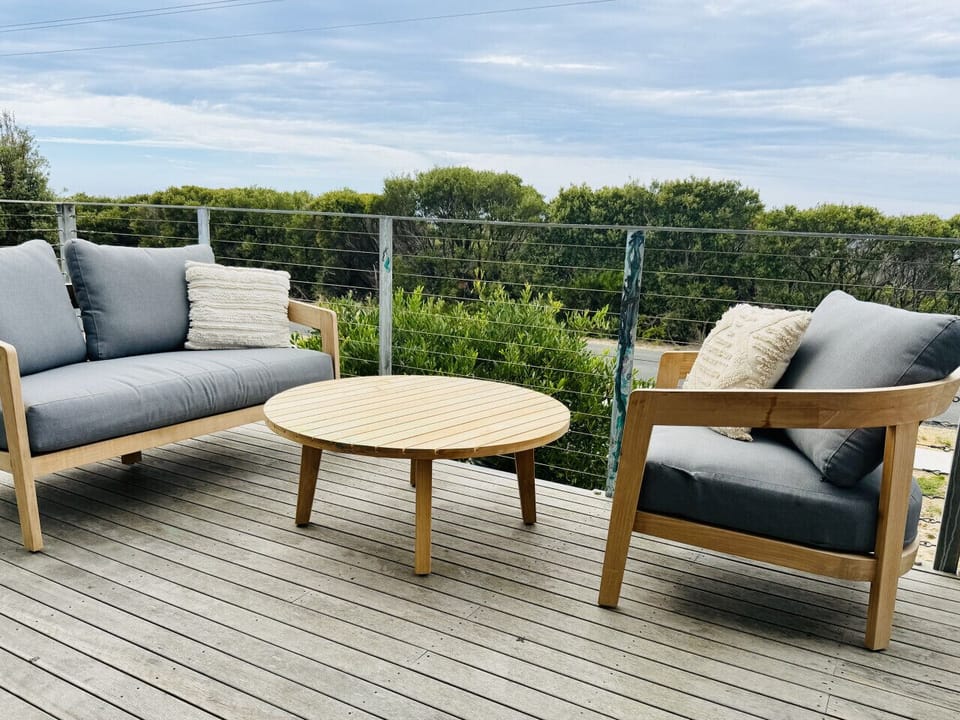 Outdoor seating area on the private deck, ideal for relaxing and enjoying the coastal surroundings.