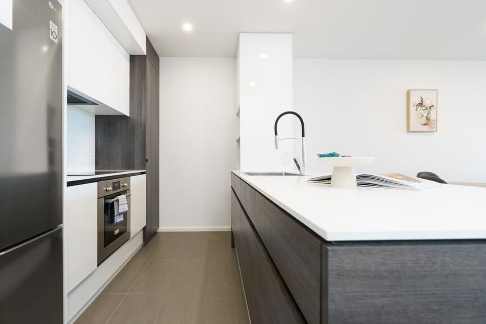 A sleek, fully equipped kitchen with quality appliances and plenty of bench space – perfect for cooking up a feast or preparing a quick brekkie before heading out.