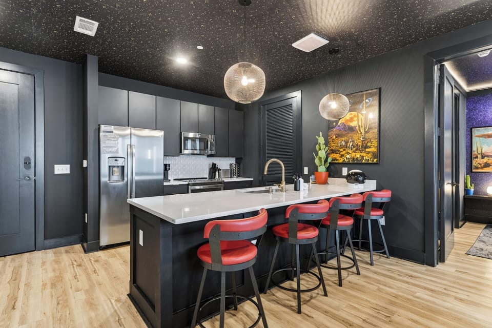 Sleek, fully equipped kitchen with a spacious island, bar seating, and modern finishes—ideal for shared meals, cocktails, and late-night chats before heading out in Nashville.
