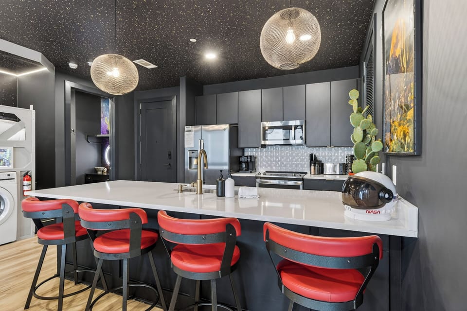 Sleek, fully equipped kitchen with a spacious island, bar seating, and modern finishes—ideal for shared meals, cocktails, and late-night chats before heading out in Nashville.