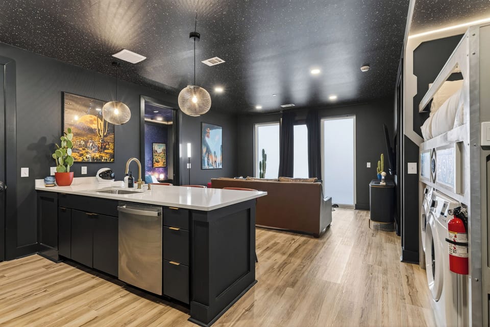 Sleek Nashville condo with a designer kitchen, modern island seating, cozy living area, and stylish finishes—perfect for relaxing after a day exploring Music City.