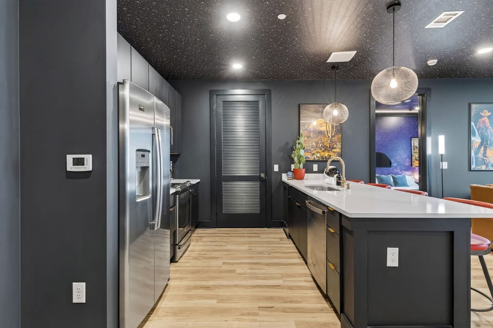Sleek, fully equipped kitchen with a spacious island, bar seating, and modern finishes—ideal for shared meals, cocktails, and late-night chats before heading out in Nashville.