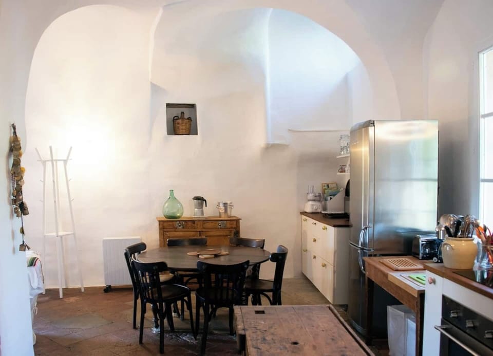 Open kitchen and dining area under beautiful vaulted ceilings.