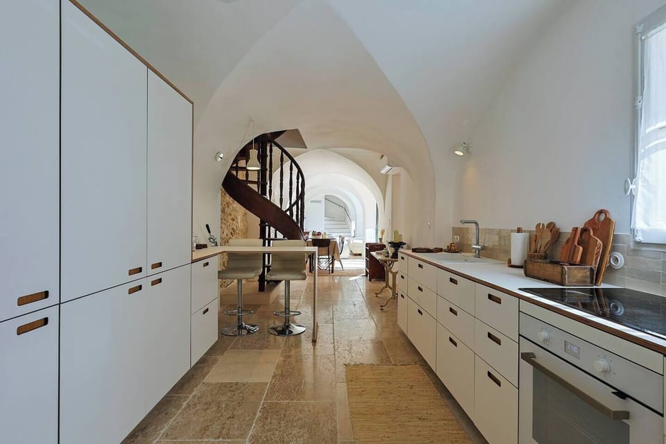 Bar counter with stools — the perfect spot for morning coffee.  Open-plan kitchen connected to the living areas, designed for easy flow and convivial living.