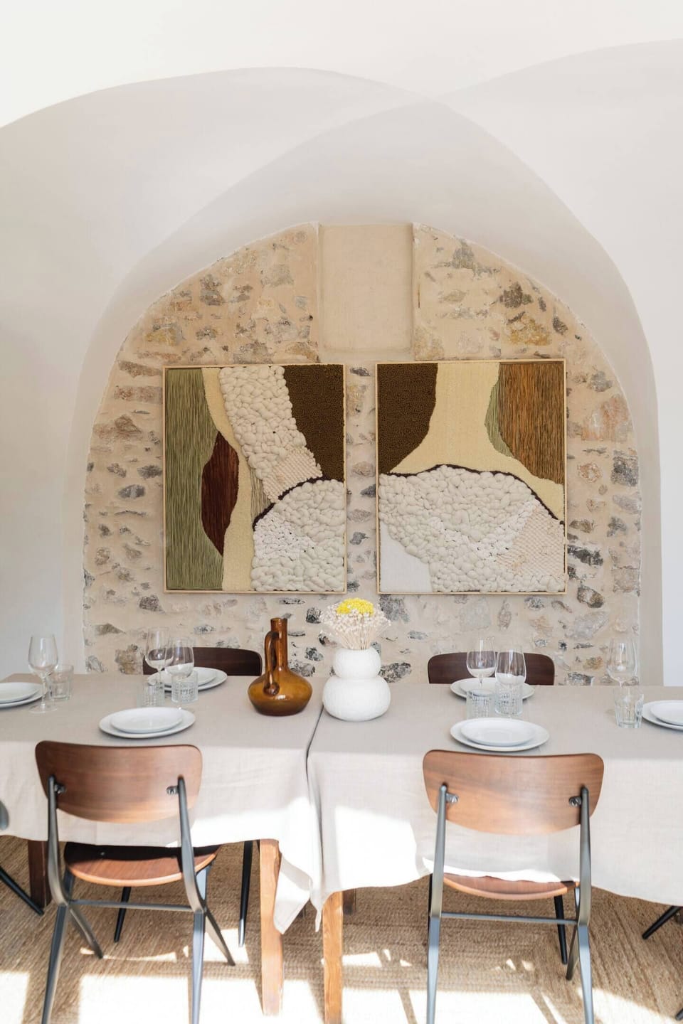 A dining area where historic stone meets curated art and understated elegance.