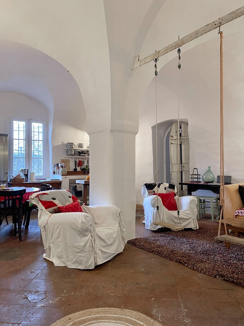 Vaulted space with swings — playful, warm, unforgettable. A/C.