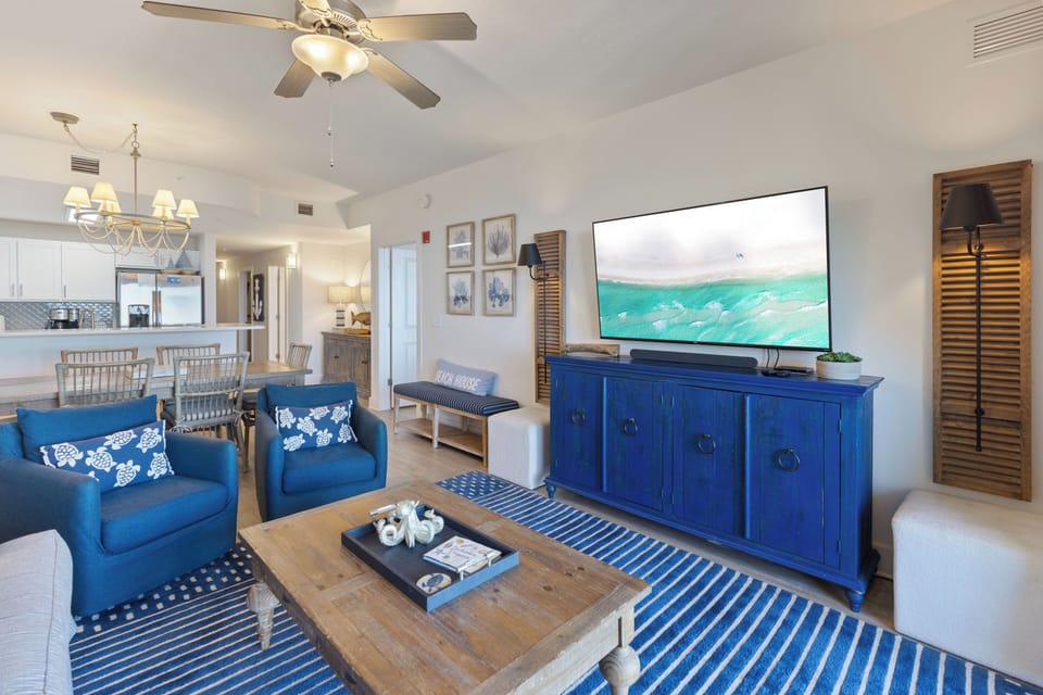 Sink into ocean-blue comfort while your favorite shows play on the large TV in this breezy coastal living space.