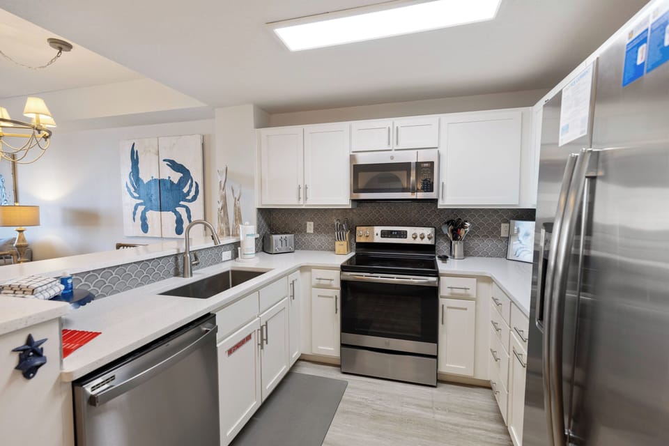 Cook your favorite meals in this bright, fully-equipped kitchen with modern appliances and charming coastal touches.