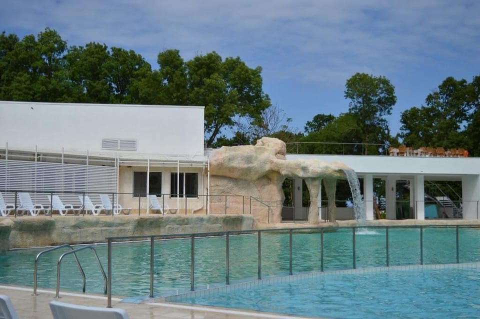 Seasonal outdoor pool, open 8:00 AM to 6:00 PM, pool umbrellas