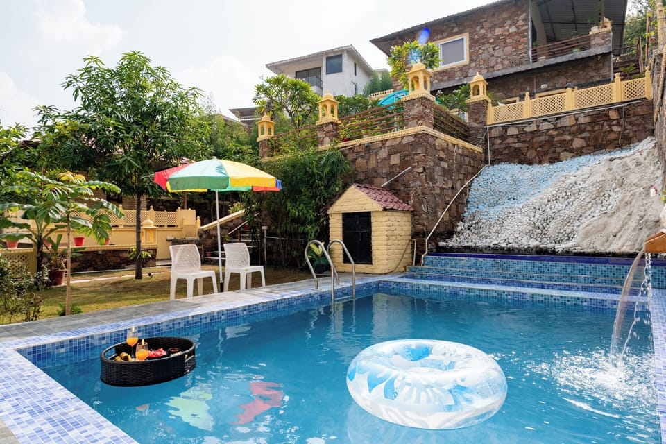 Swimming pool with natural fountain and ambarella 