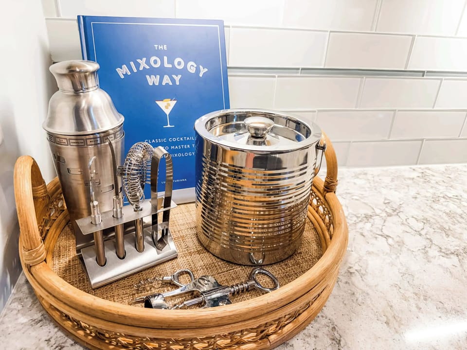 Craft the perfect evening with our curated mixology station, featuring professional-grade tools and 'The Mixology Way' guide for the aspiring connoisseur.