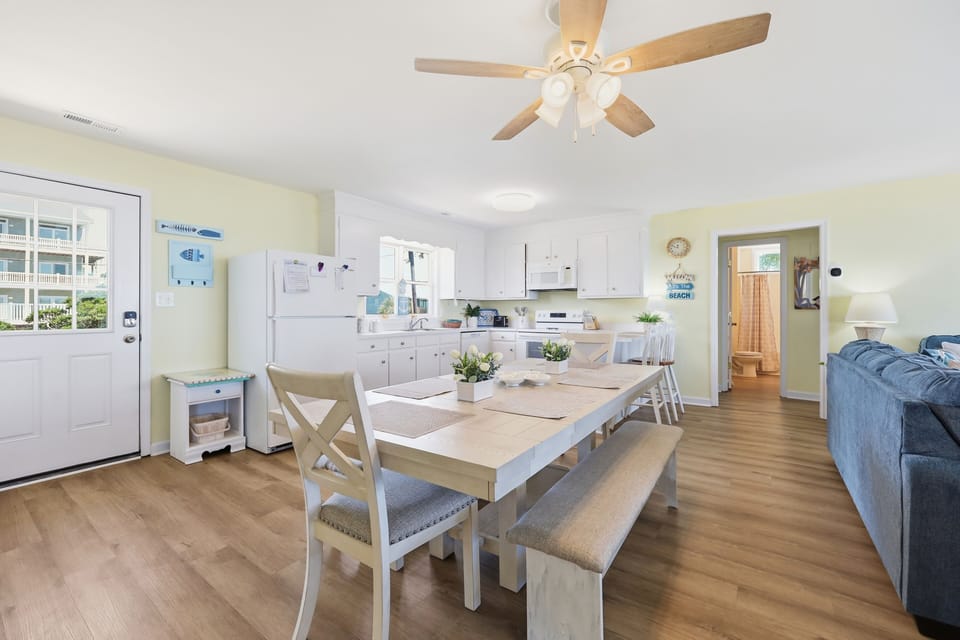 Gather around your spacious dining table with seating for everyone, opening to a fully equipped kitchen and relaxing living area—perfect for making vacation memories together.
