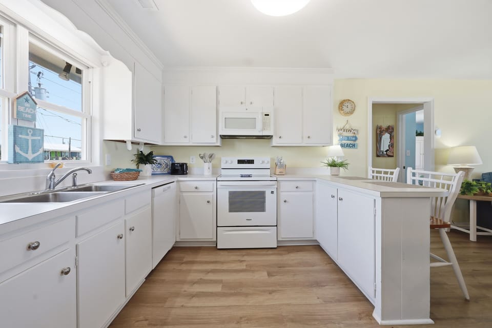 Picture yourself preparing fresh morning coffee in this bright, welcoming kitchen with ample counter space and everything you need for home-cooked meals during your stay.