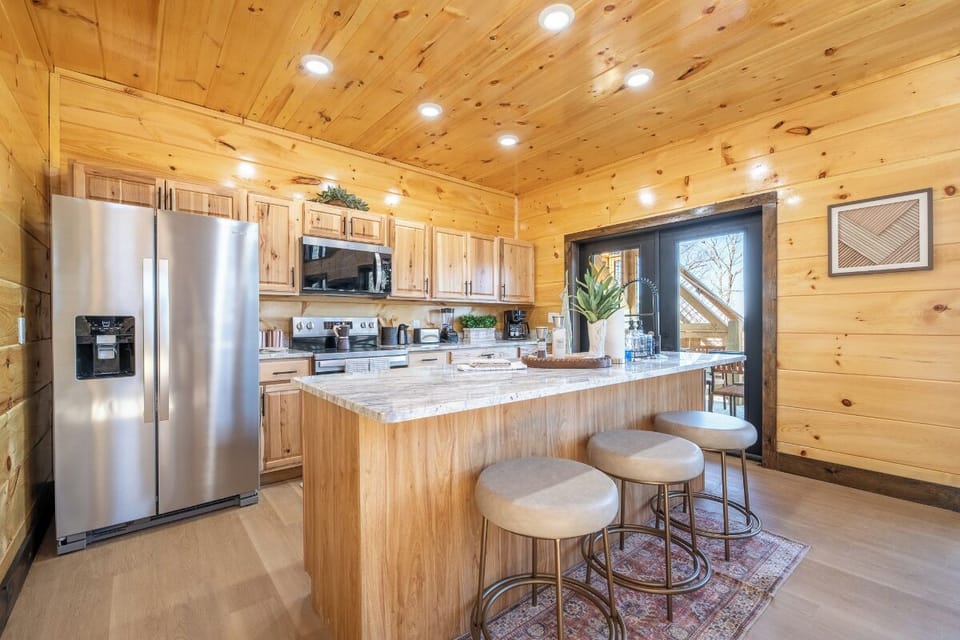 Your rustic-chic kitchen invites culinary adventures with warm wood accents, granite counters, and modern appliances creating the perfect gathering space.