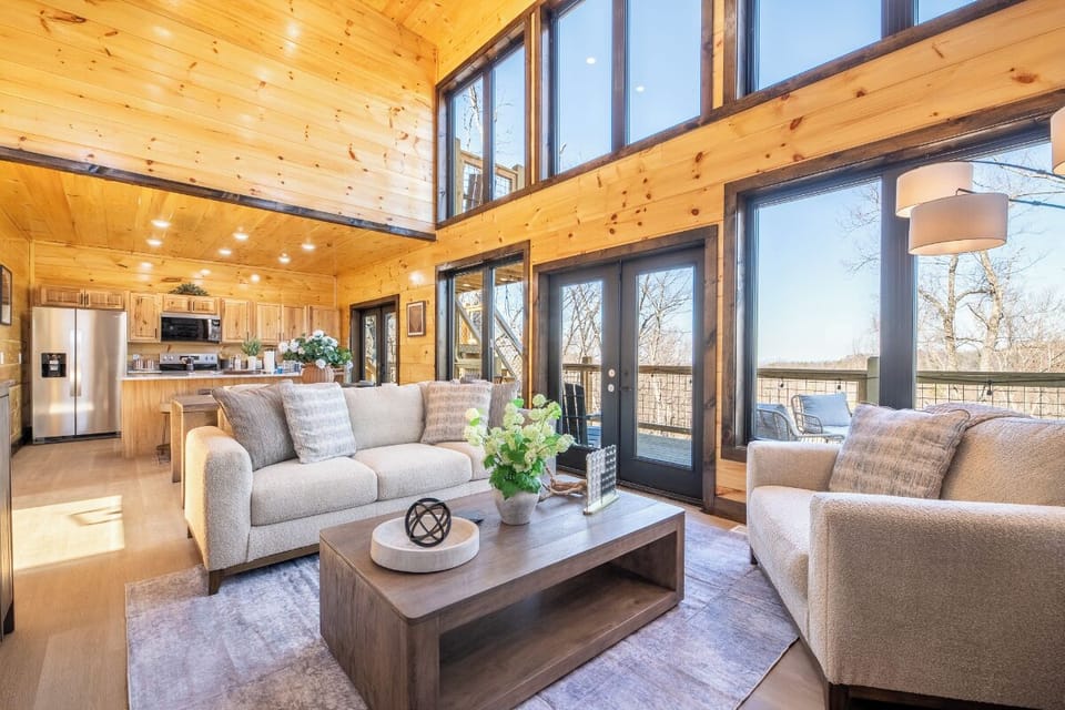 Relax in your spacious living area with soaring wood ceilings and expansive windows that flood the room with natural light.