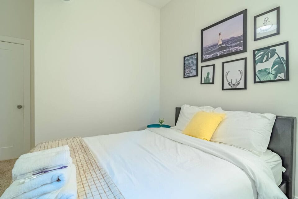 Clean, cozy bedroom with comfortable bedding, soft lighting, and a relaxing atmosphere for a restful stay.