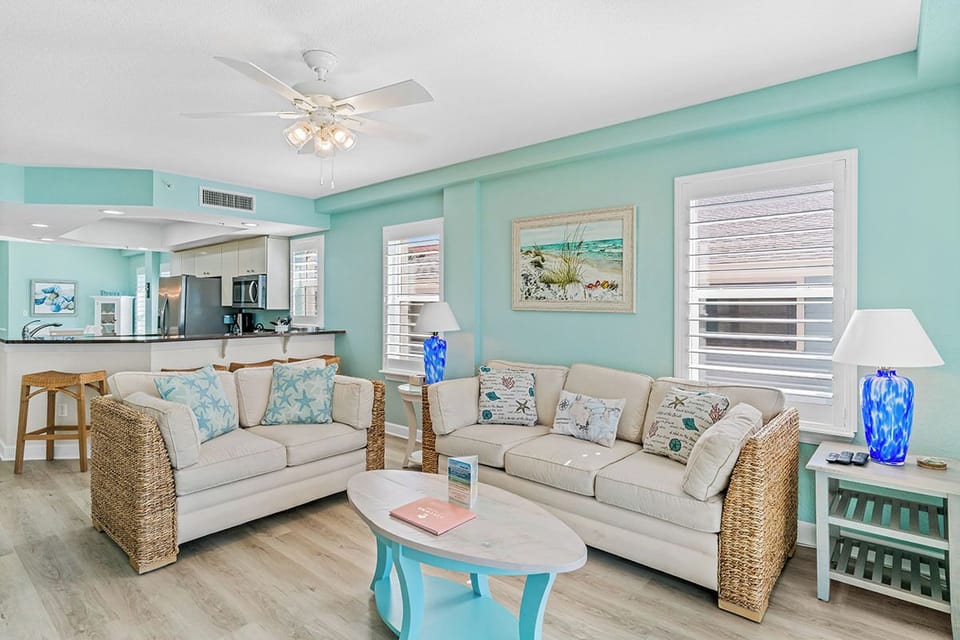Relax in your coastal-inspired living room where soft blues and natural textures create a serene atmosphere for unwinding after beach adventures.