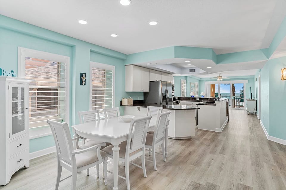 Enjoy cooking and dining in this spacious, bright kitchen with modern appliances and coastal charm.