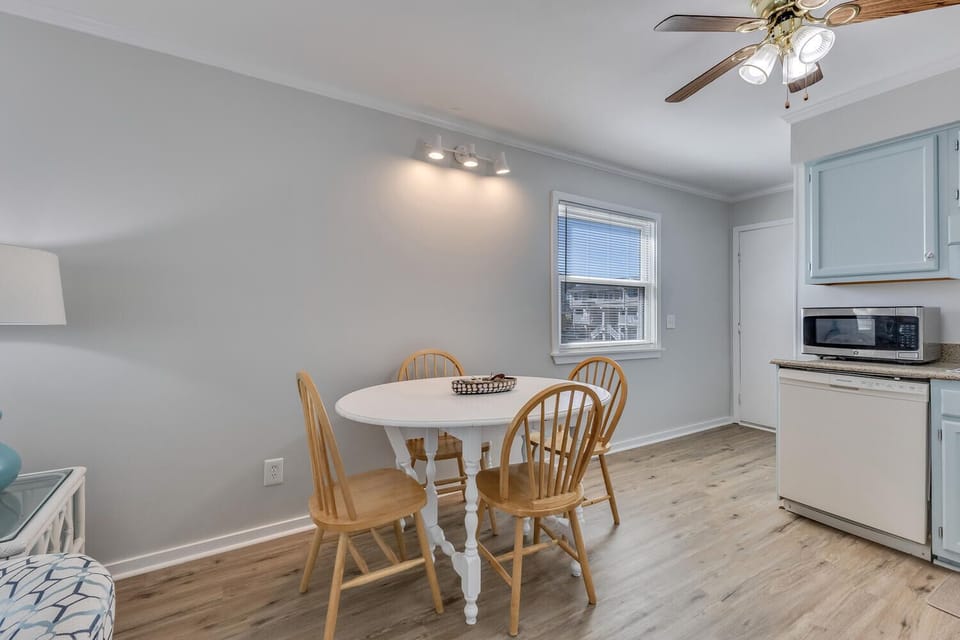 Gather around your charming dining table for morning coffee or evening meals in this bright, airy space with coastal charm.