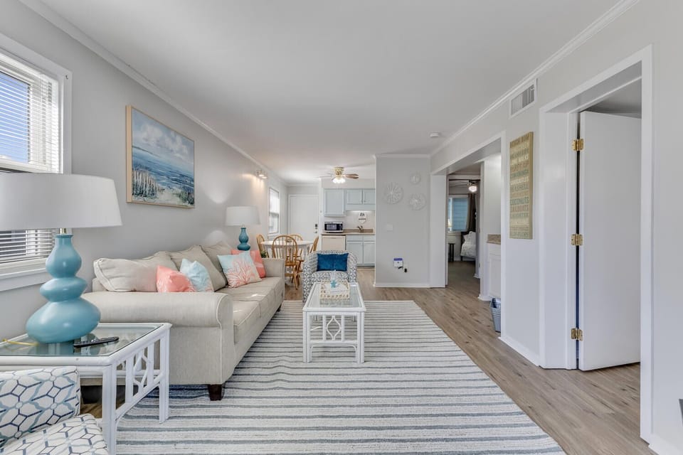 Settle into this bright, coastal-inspired living space where soft blues and whites create your perfect beach retreat atmosphere.