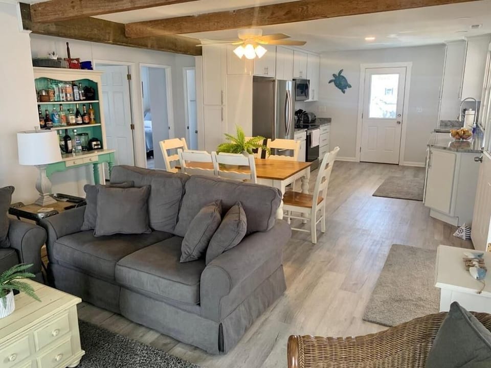 The open layout seamlessly connects the living and dining areas, creating a warm and welcoming space with a clear view into the kitchen.