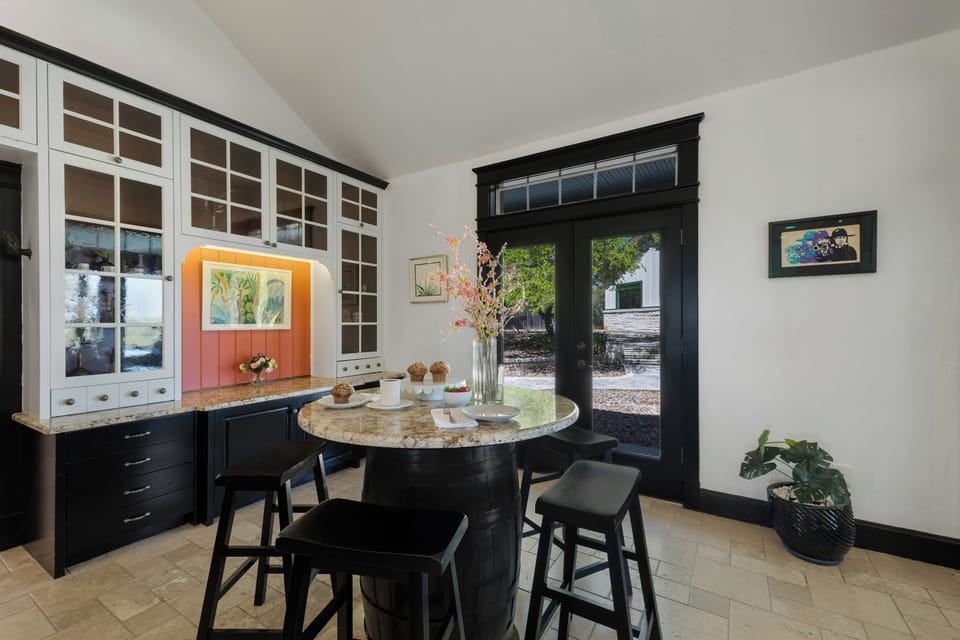 Gather around this elegant marble-topped table for morning coffee with garden views streaming through your French doors.