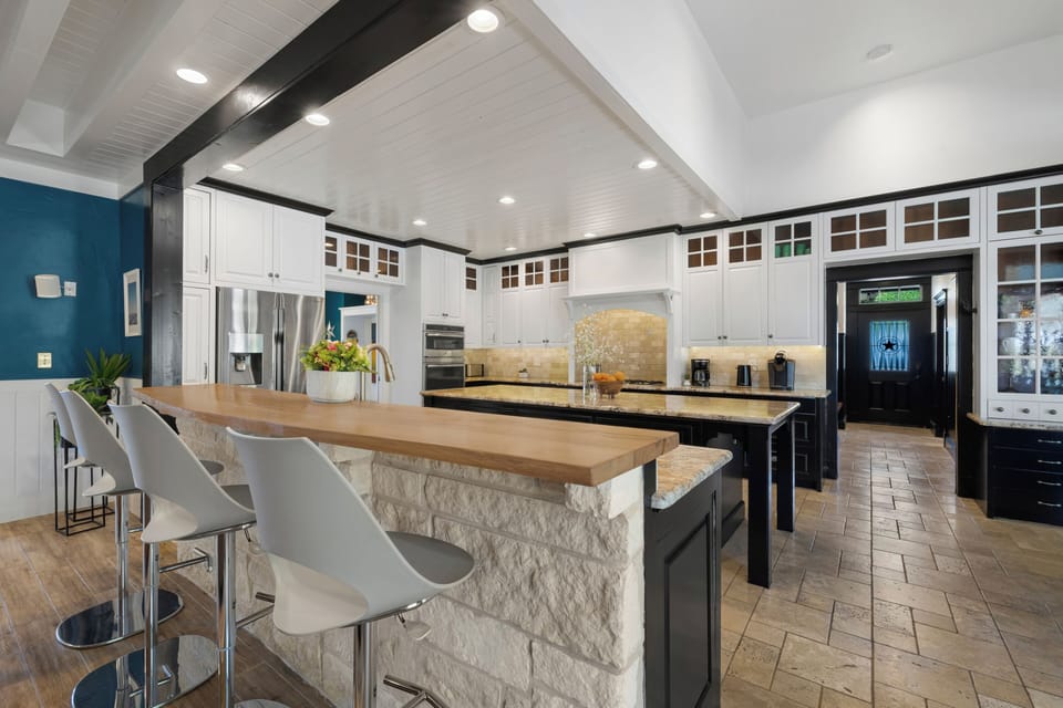 Your dream kitchen awaits with a stunning stone island perfect for morning coffee and culinary adventures together.