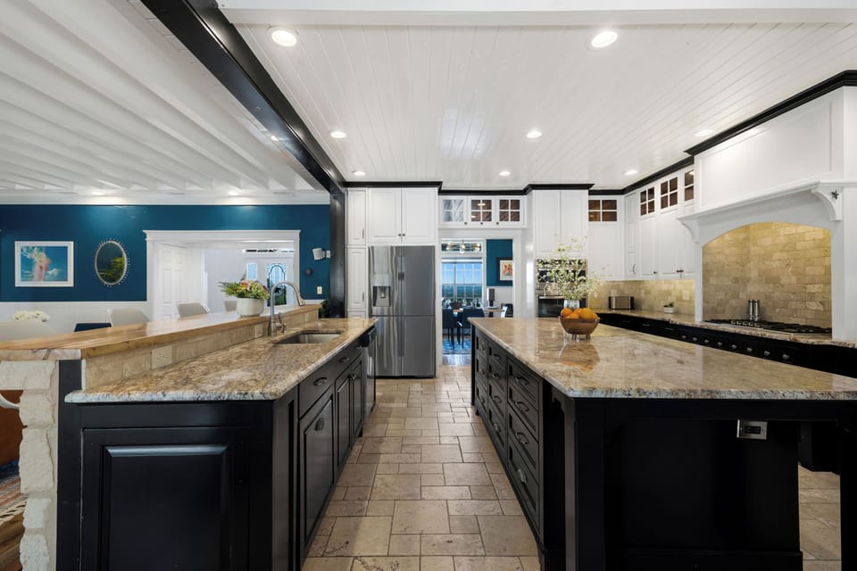 Cook memorable meals in this stunning chef's kitchen featuring granite countertops, premium appliances, and ample prep space for your culinary adventures.