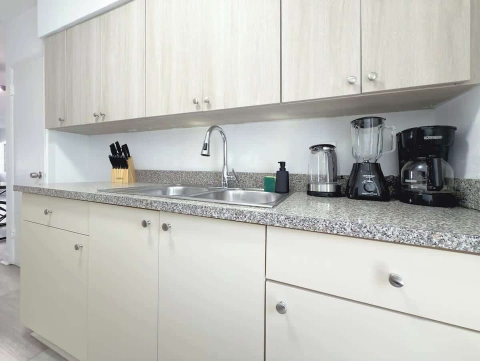 Fully equipped kitchen with stove, fridge, microwave, and all essential cookware (no dishwasher).