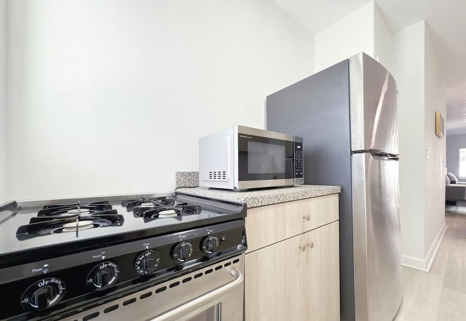 Fully equipped kitchen with stove, fridge, microwave, and all essential cookware (no dishwasher).