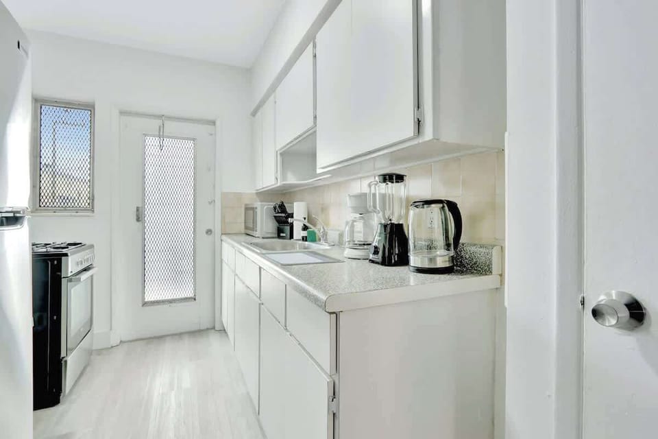 Fully equipped kitchen with fridge, stove, microwave, and essential cookware (no dishwasher).